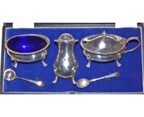 A silver three piece cruet set by Walker and Hall, London 1936 of baluster form, with gadrooned borders, raised on pad feet, 