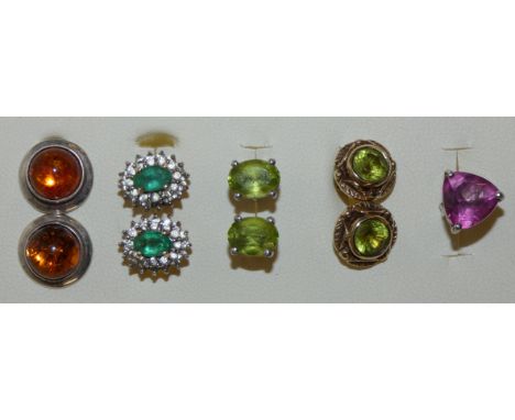 A pair of 9ct gold peridot ear studs, another pair of 9ct gold studs and two and a half silver ear studs