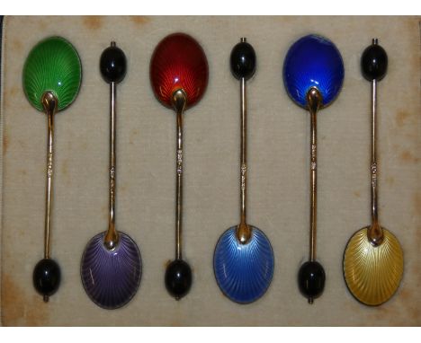 A set of six silver gilt and enamel coffee bean spoons, Birmingham 1932 with guilloche enamel decoration