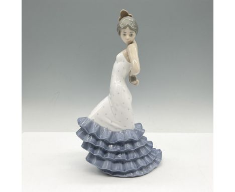 This enchanting figural is in dance pose dressed in white bodice dress with blue ruffles. Nao by Lladro backstamp. 418. This 