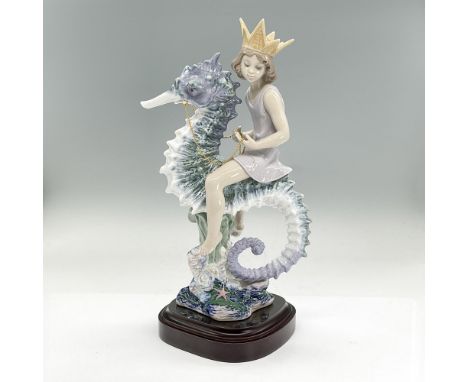 Glazed porcelain figure of an undersea prince sitting on a blue and white seahorse. Lladro backstamp. This item has its origi