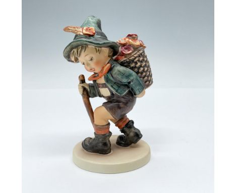 Matte porcelain figurine depicting a young man selling flowers from a basket on his back. Goebel TMK5. Issued: 1972-1979Dimen