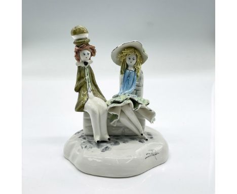 Glazed porcelain figure of young man and lady sitting on a bench. Signed by artist. Artist: Lino ZampivaDimensions: 3.5"L x 3