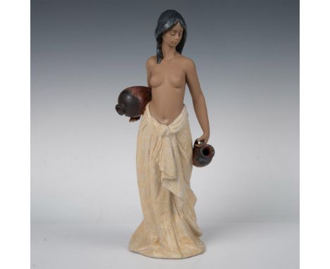 Gres finish porcelain figure of a topless young lady wearing a tied skirt, carrying vessels for water. Lladro backstamp. This