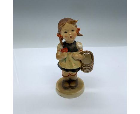 Hand-painted figurine depicting a young girl holding a basket and flowers. Goebel backstamp on the bottom. Dimensions: 3"L x 