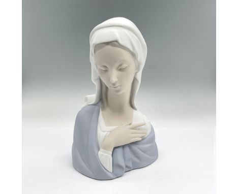 Matte porcelain bust of the iconic Mary in a white headdress and blue shawl. Lladro backstamp. Artist: Vincente MartinezIssue