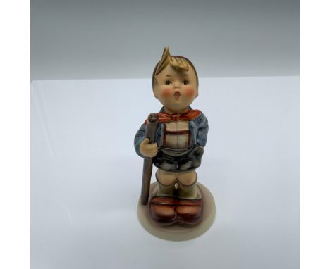 Hand-painted figurine depicting a boy with a walking stick. Goebel backstamp on the bottom. Dimensions: 2.75" dia. x 5.75"HMa