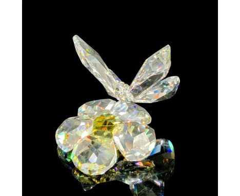 This retired Swarovski figurine is made from clear faceted crystal, and the flower has a Jonquil (light yellow) center. Swaro