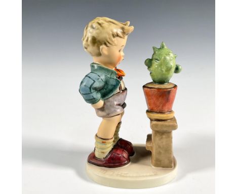 Hand painted figure of a young boy looking at a cactus. Goebel TMK 5. Issued: 1972-1979Dimensions: 4"L x 2.75"W x 5.75"HManuf