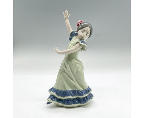 Glazed porcelain figure of a young Flamenco dancer girl in a green and blue dress. Lladro backstamp. This item has its origin