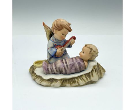 figurine of little angel in blue dress singing to a baby wrapped in purple blankets. Small candle holder on the side. Goebel 