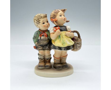 Hand-painted porcelain figurine depicting a young Bavarian boy and girl, most likely siblings, setting off for a day at the m