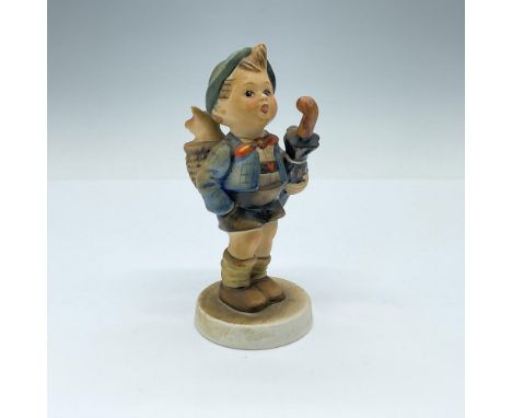 Matte porcelain, hand-painted figurine featuring a young boy carrying a pig in a basket. Goebel TMK4. Issued: 1964-1972Dimens