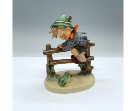 Hand-painted figurine depicting a boy climbing a fence to escape a frog. Goebel backstamp on the bottom. Dimensions: 4.5"L x 