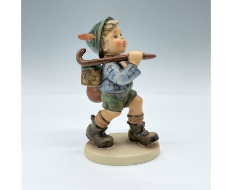 Matte-finish, hand-painted porcelain figurine depicting a boy hiking with lots of his belongings. Goebel TMK 5. Issued: 1972-