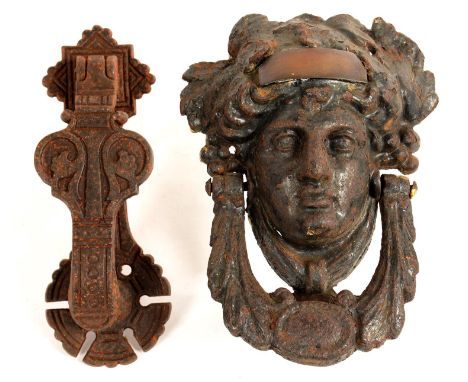 A VICTORIAN CAST IRON MASK DOOR KNOCKER, 20CM H AND A LATE VICTORIAN CAST IRON DOOR KNOCKER BY KENRICK AND SONS, MARKED AK &a