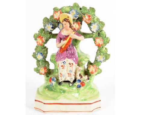 A STAFFORDSHIRE EARTHENWARE ARBOUR FIGURE OF A SEATED WOMEN PLAYING AN INSTRUMENT, 16CM H 