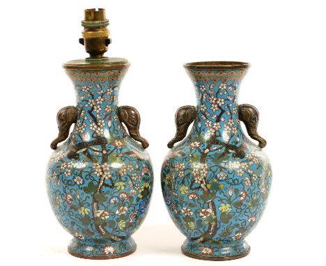 A PAIR OF CHINESE ELEPHANT HANDLED CLOISONNE ENAMEL VASES, DECORATED WITH BIRDS IN BRANCHES ON A TURQUOISE GROUND, 22CM H, ST