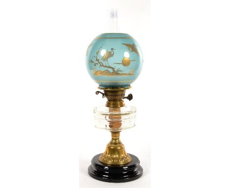 A VICTORIAN BRASS OIL LAMP WITH FACETED GLASS FOUNT AND BRASS BURNER, GLAZED POTTERY FOOT, AESTHETIC GILT BLUE GLASS GLOBE, 4