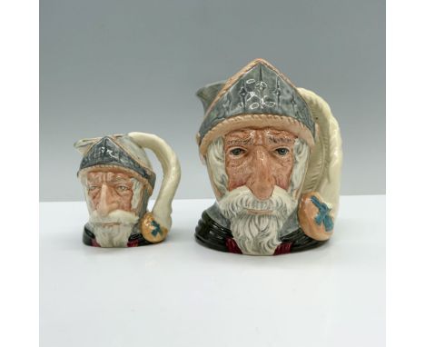 A pair of jugs depicting Don Quixote, clad in a knight's uniform of red, black, and gray, sports a long, flowing white beard 