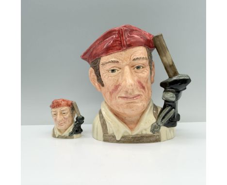 A pair of jugs depicting a blacksmith, dressed in a brown apron, white shirt, and red hat, with a handle crafted from a hamme
