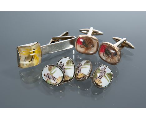 SPORTING JEWELLERY
comprising a pair of enamel porcelain shooting cufflinks, a pair of trout fly cufflinks and a trout fly ti