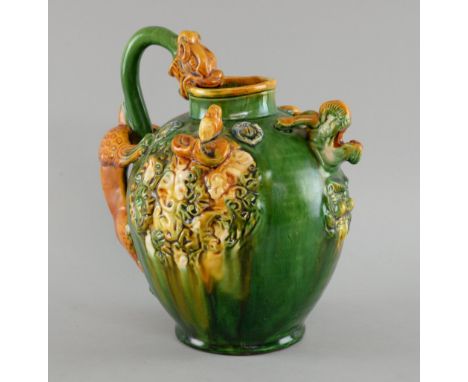 Chinese green and yellow glazed jug with applied dragon handle, figural and mask decoration, impressed seal mark to base, 25c