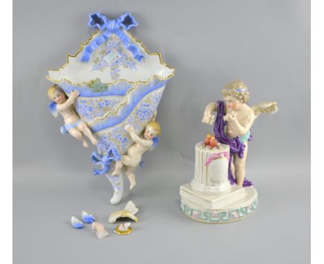 Porcelain wall pocket with two cherubs and a figure of a cherub over Corinthian pedestal, together with a Dresden lamp decora