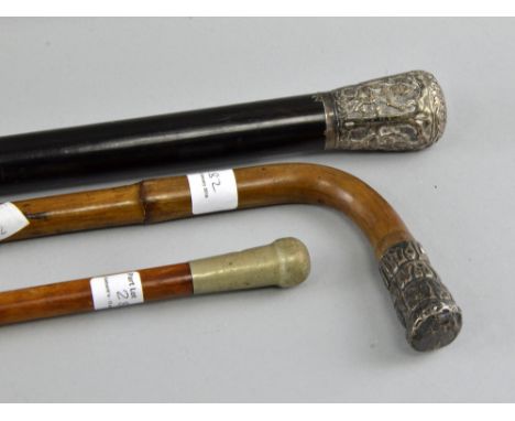 Ebonised walking stick with white metal pommel and two others