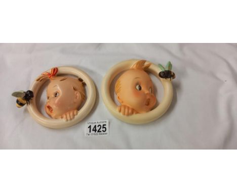 A Goebel Hummel baby boy and baby girl plaques, marked 30 OA and 30/08 