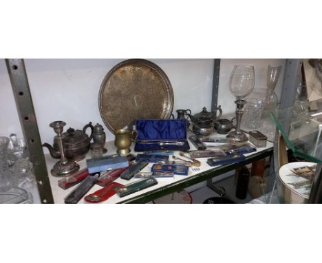 A large shelf of metalware, silver plate tea set, candlesticks &amp; tourist spoons etc. COLLECT ONLY 