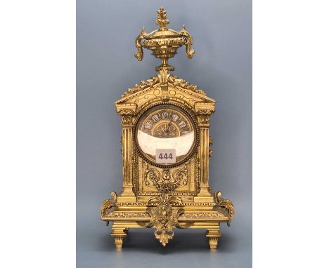 A French brass cased mantel clock striking on a coiled rod, the sides and triangular pediment adorned with flowers, the face 