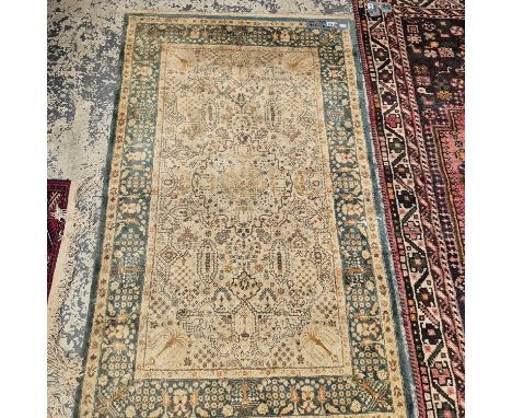 An Oriental rug of Agra design 158 x 97 cm, with another oriental rug of Persian design. 202 xz 122 cm (2)