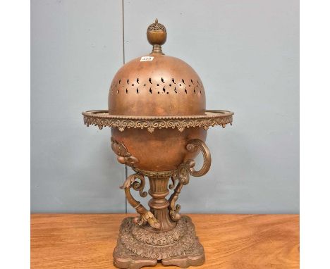 A copper brazier and domed cover, the cup shaped body raised on a column and four brackets above the wavy edged square foot. 