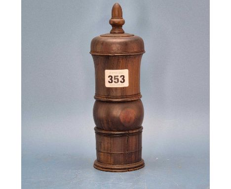 A lignum vitae coffee grinder, the ground pepper collected within the screw on cup base