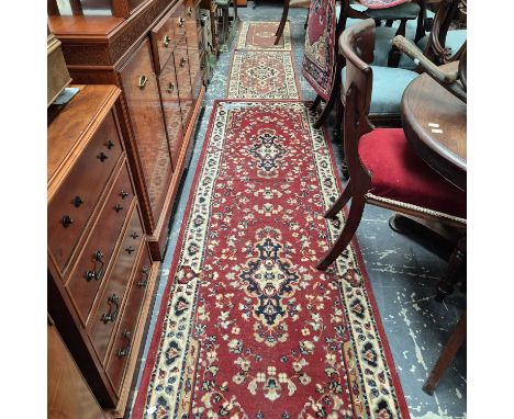 A machine made runner of Persian design. 250 x 80 cm together with three oriental style mats (4)