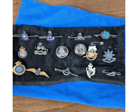 A collection of enamel military and other badges, WWI and coronation medals, cufflinks and buttons
