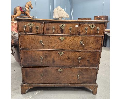 An 18th century oak chest of three short drawers over three graded long drawers and bracket feet.   W 102 x D 54 x H 97cms.