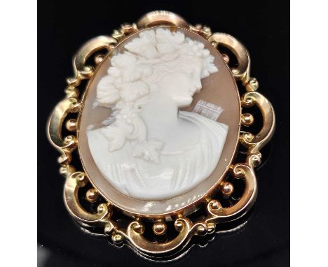 An antique portrait cameo brooch complete with a safety chain. The brooch frame is stamped 9ct, assessed as 9ct gold with a r