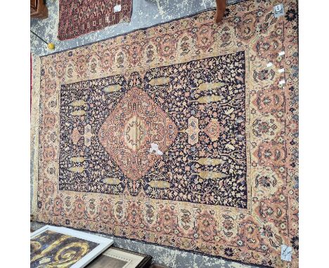 A machine made rug of Persian design 206 x 148 cm