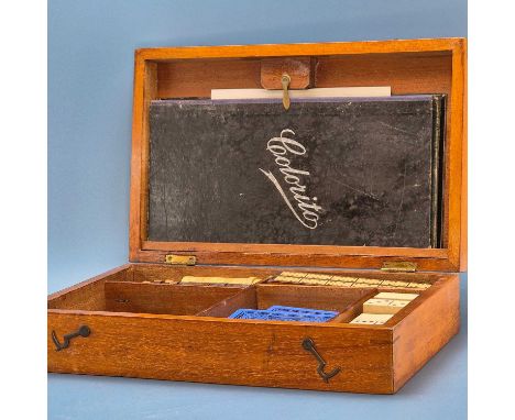 A mahogany games compendium comprising: chess, draughts, dominoes, horse racing, boards and counters 