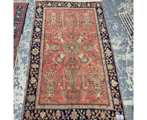 An antique Persian sarouk rug. 118 x 192 cm