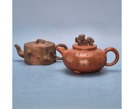 Two Yixing tea pots, the darker red ware modelled as a tree trunk section, the bun shape of the other inscribed and with a li