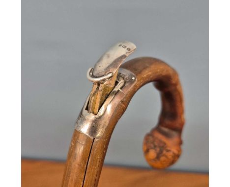 A silver mounted bamboo walking stick containing a measure for horses in hands and metres together with a silver topped walki