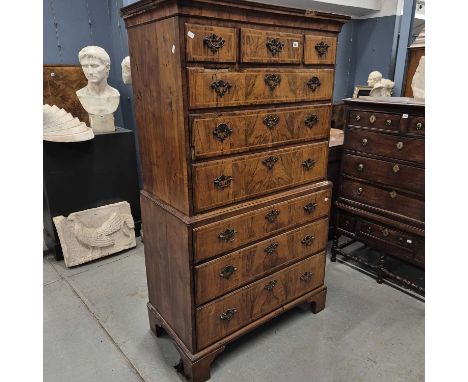 A George III line inlaid walnut chest on chest, the top with three drawers above three graded long drawers, the base with thr