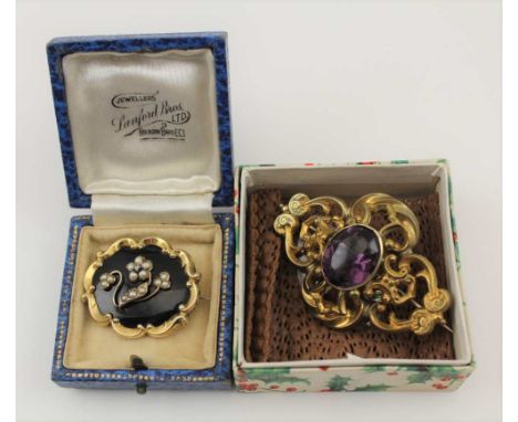 A VICTORIAN PINCHBECK BROOCH set central amethyst colour stone, together with a seed pearl set and a black enamel MOURNING BR