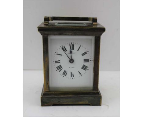 A FRENCH CARRIAGE CLOCK, the brass case with bevelled glass panels, movement by R &amp; Cie made in Paris, white enamel face 