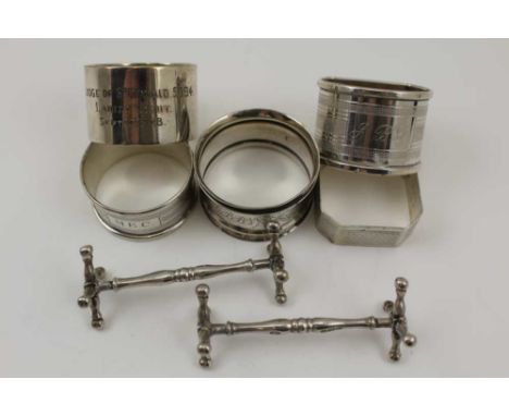 WILLIAM HUTTON &amp; SONS LTD A PAIR OF EDWARDIAN SILVER KNIFE RESTS, Sheffield 1905, together with FOUR ASSORTED SILVER NAPK