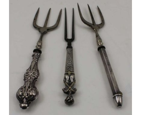 TWO SILVER HANDLED BREAD FORKS and a two prong fork with white metal figurative handle 