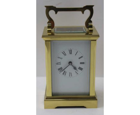 A BRASS FRAMED CARRIAGE CLOCK, bevel glass panels, white enamel face with Roman numerals, height of case; 11.5cm (excluding f